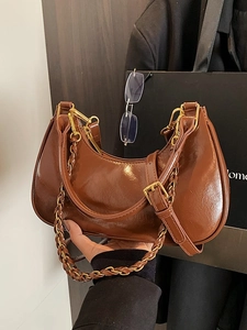 Retro brown half-moon crossbody bag with glossy finish and gold chain strap
