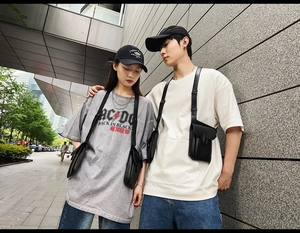 Tactical black PU leather crossbody bag with modular system shown on models in street style