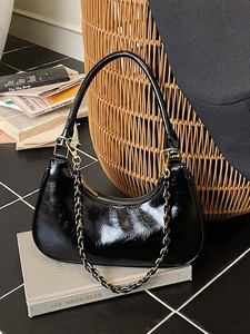 Retro black glossy leather dumpling bag with gold chain strap for elegant shoulder wear