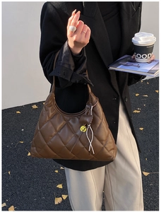 Quilted brown hobo bag featuring detailed diamond stitching and yellow smiley charm