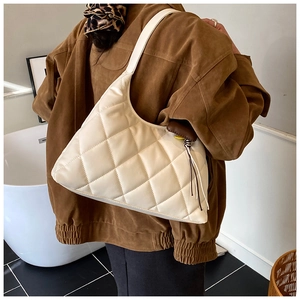 Quilted hobo shoulder bag in beige shown on model for a trendy commute and casual style