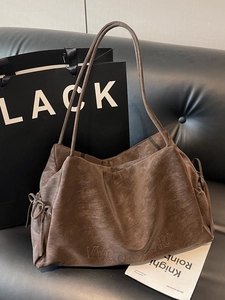 Vintage brown leather tote bag with side drawstring bows and slim shoulder straps