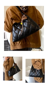 Close-up of quilted tote bag with brown leather tassel and yellow smiley face pendant