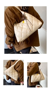 Detailed views of a cream quilted hobo bag with vintage stitching and heart charm