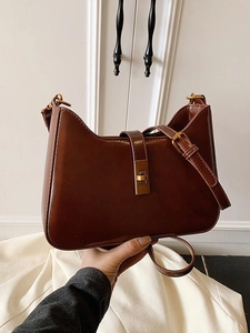 Minimalist brown retro half-moon underarm bag in smooth leather with gold buckle