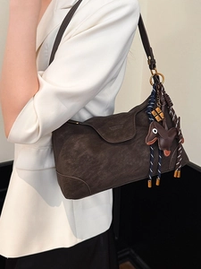 Dark brown matte suede shoulder bag with trendy dachshund charm and woven straps