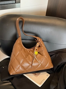 Brown quilted hobo shoulder bag with diamond stitching and yellow smiley charm