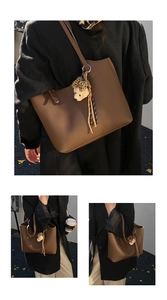 Detail of brown litchi pattern leather tote bag with plush bear charm and leopard ribbon