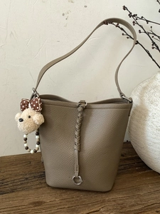 Vintage khaki brown leather bucket bag with a cute teddy dog charm and silver metal ring
