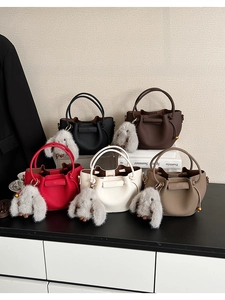 Detail of multi-color bucket bags with lychee pattern and cute rabbit pendants