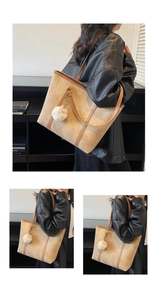 Close-up and lifestyle view of a large khaki tote bag with brown handles and fur ball