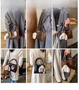 Detail view of stylish tote bags in brown and black with rabbit plush charms