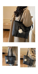 Close-up of stone texture tote bag with sheep pendant and slim black shoulder straps