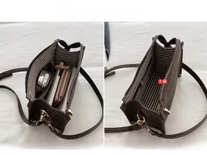 Vue intérieure du sac bandoulière en cuir marron avec doublure rayée et rangement