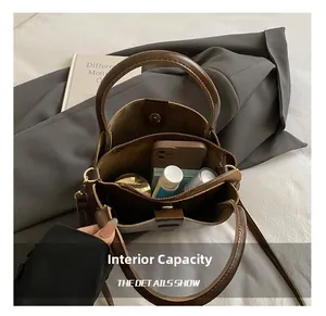Internal view of brown leather handbag showing main compartment and magnetic closure