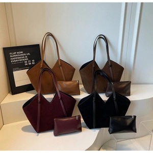 Detail of four-color suede tote bags with matching leather pouches on display stand