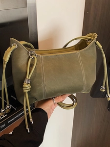 Dark green shoulder bag with drawstring knot detail and white stitching for women