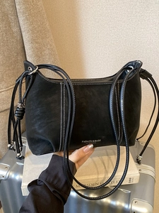 Chic black matte leather crossbody bag with white stitching and bead drawstring detail