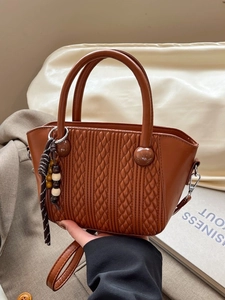 Vintage brown woven quilted bucket bag with circular handle and beaded tassel charm