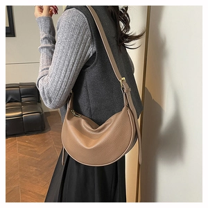Detail of soft lychee pattern leather and adjustable strap on a vintage hobo bag