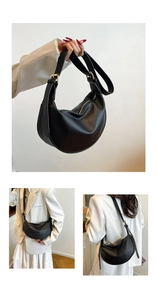 Detailed view of black pebbled leather hobo bag with gold hardware and adjustable strap