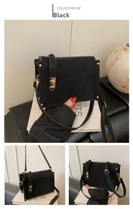 Detail of black crossbody bag featuring gold twist lock and metallic side rivets