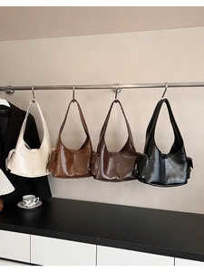 Multi-color vintage wax leather tote bags hanging in beige, brown, and black options