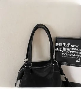 Detail of Malodi tote bag with silver hardware and natural leather texture finish