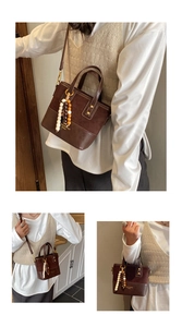 Close-up of brown bucket bag showing mixed leather textures and decorative wooden beads