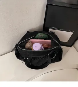 Macro view of large black tote bag interior showing ample space for tablets and daily items