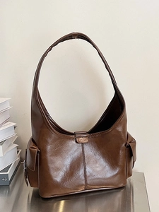 Retro wax leather brown tote bag with side flap pockets and a wide shoulder strap