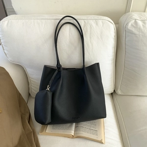 Détail du cabas noir en similicuir avec texture grainée et mini pochette assortie