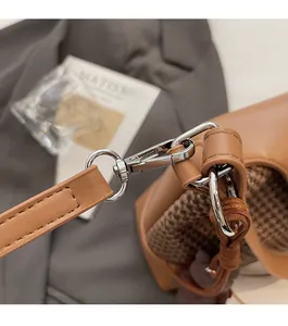 Detailed close-up of premium silver rotating metal clasp and brown leather strap