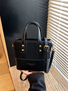 Minimalist black crossbody tote bag with gold lettering and adjustable strap for women