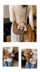 Detail of a brown bucket bag with plush bunny charm and adjustable shoulder strap