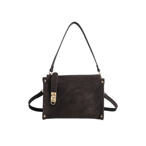 Detailed view of deep brown vintage handbag featuring golden buckle and rivet accents