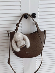 Dark brown lychee pattern leather handbag with plush bunny charm and shoulder strap