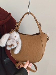 Brown litchi leather handbag with plush rabbit charm and silver metal hardware
