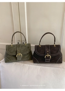 Macro detail of suede handbags in olive green and brown with contrast stitching