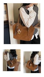 Brown large suede tote bag detail with cute bear pendant and woven tassel charm