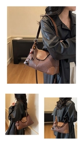 Detail of a brown woven shoulder bag with leather trim and a cute plush bunny charm