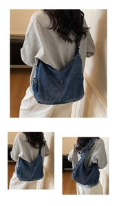 Detail of blue denim tote bag featuring a round metal logo and gathered drawstring strap