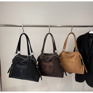 Three leather tote bags in black, coffee, and tan with daisy embroidery and Maodi logo