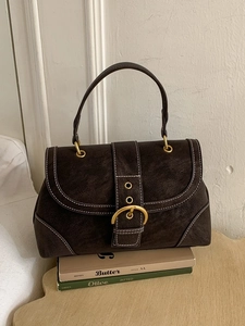 Vintage dark brown handbag with white contrast stitching and a gold horseshoe buckle