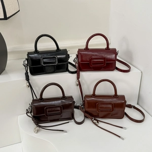 Detail view of four vintage leather mini square bags in black, burgundy, coffee, and tan