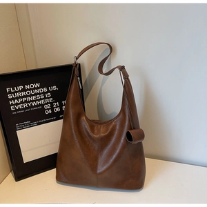 Brown vintage hobo tote bag with adjustable metal buckle strap and soft leather texture