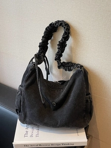 Retro washed black denim hobo bag with scrunchie strap and drawstring side pockets