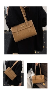 Close-up of tan matte leather underarm bag with gold metal logo and strap details