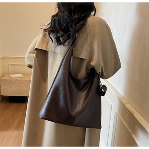 Detail of a dark brown large capacity faux leather hobo shoulder bag with a minimalist design