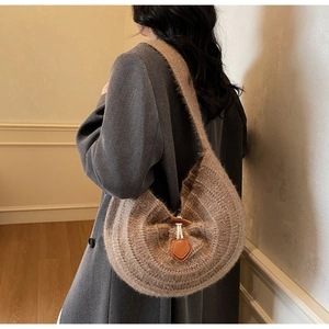 Detail of soft brown knit tote with fuzzy texture and wooden horn toggle closure